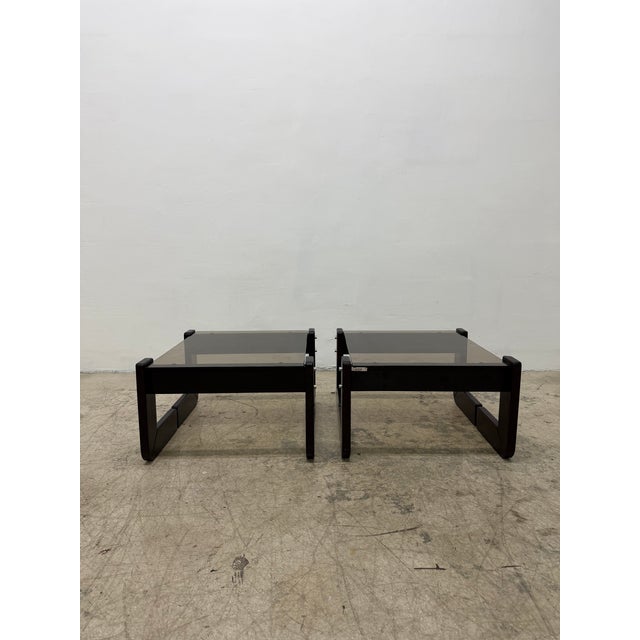 Pair of rosewood and smoked glass side tables by Brazilian designer Percival Lafer circa 1970s.