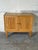 This compact storage cabinet features double doors opening to an interior shelf for organized storage. Textured reeded...
