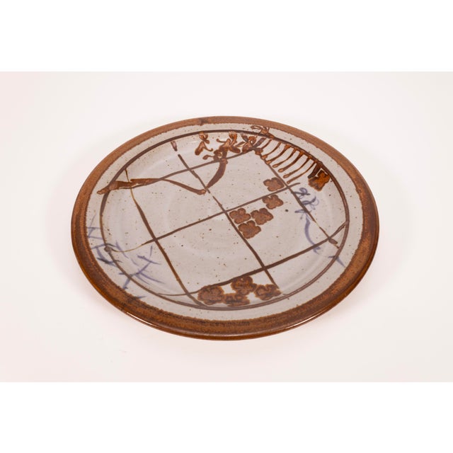 A modernist stoneware glazed ceramic set of 5 plates by Detroit artist John Glick of Plum Tree Pottery. Circa late 20th...