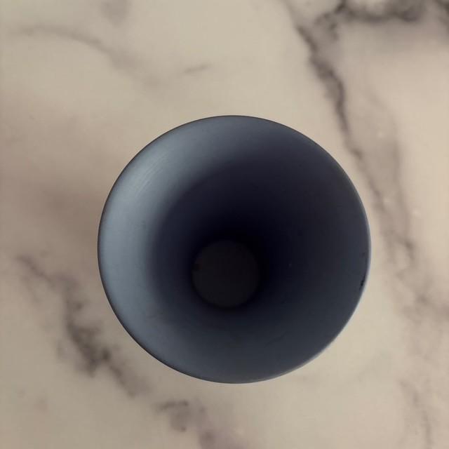 A pretty and petite Wedgwood vase. Classic blue and cream colored pottery. Stamped on bottom. Made in England.