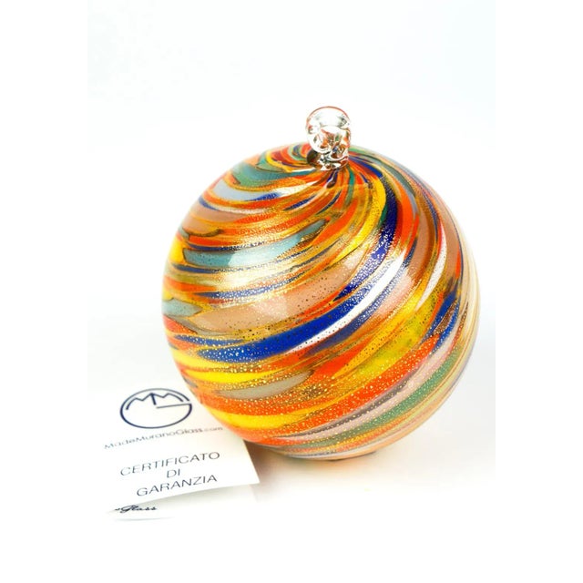 Christmas ball blown Murano glass with multi-color processing and detail in 24k gold leaf. Entirely hand made by our...