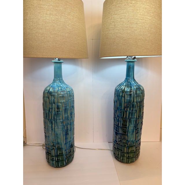 Specifically known for its vibrant teal glaze and distinctive bottle silhouette, these handmade ceramic pieces and hand...