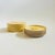 A vintage yellow lacquerware coaster set. The set includes 6 coasters that stack neatly into a circular box. A lovely...