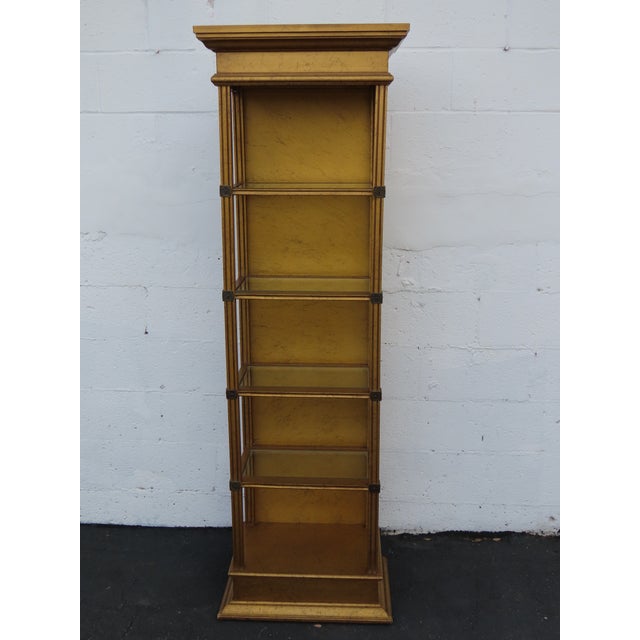 This Shelving Display Cabinet is made of wood, and glass. The Cabinet has a great Hollywood Regency style, with a classic...