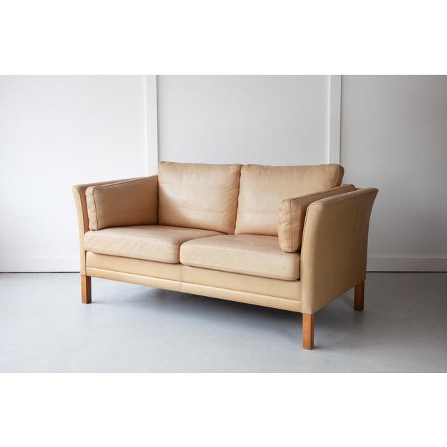 A sweet two-seater sofa in soft tan leather which was made in Denmark in the 1970s, in the style of Borge Mogensen. The...