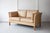 A sweet two-seater sofa in soft tan leather which was made in Denmark in the 1970s, in the style of Borge Mogensen. The...