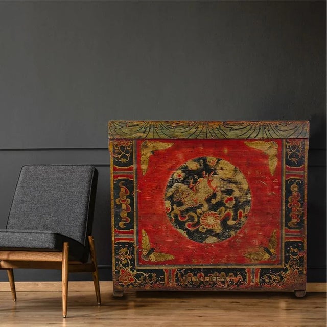 The front of this antique cabinet is decorated with hand painted mystic bird in the center, butterflies at four corners...