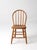 Classic vintage Windsor-style chair with a gracefully curved hoop back, turned spindle details, and a shaped wood seat...