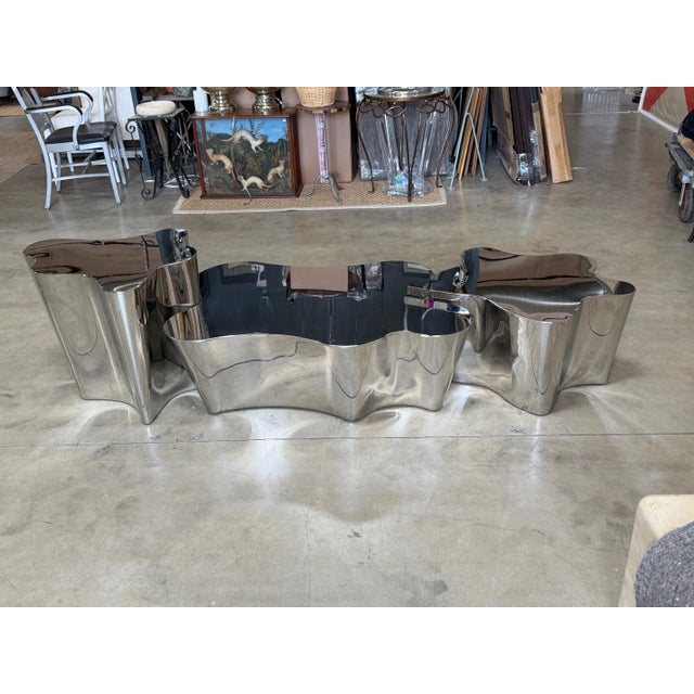 Three-piece biomorphic coffee table in polished stainless steel, dating to the early 2000s. Each table is a separate...
