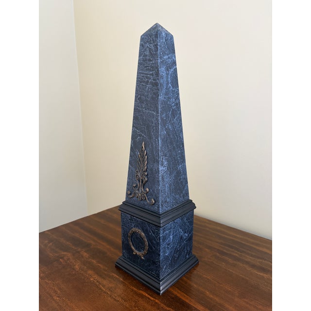 A stunning neoclassical or Grand Tour style black and grey faux-marbled pattern obelisk with brass mounts Late 20th...