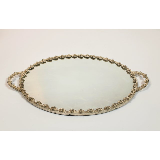 A stunning mirrored vanity tray with filigree golden roses painted creamy white. The underside is velvet. You will enjoy...