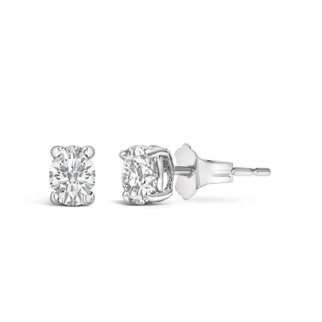Immerse yourself in the elegance of these 14K white gold stud earrings, each graced with an ethically sourced, lab-grown...
