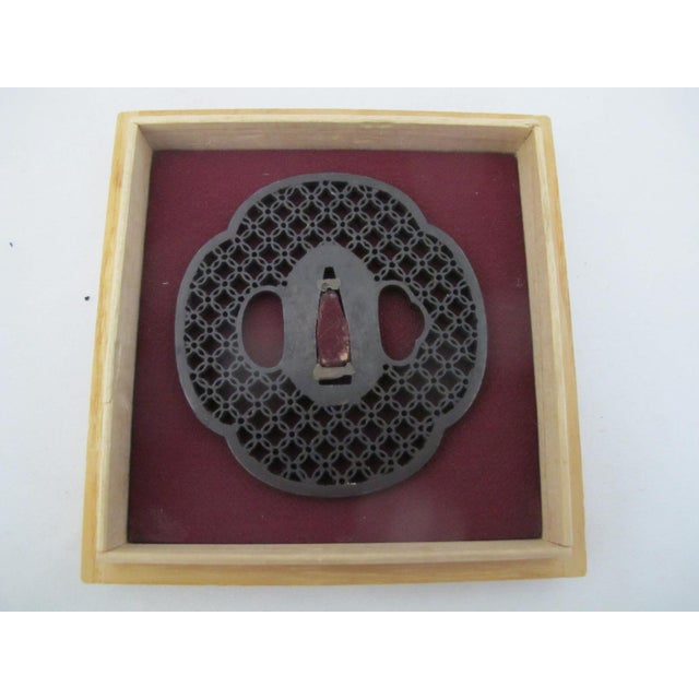 Antique Japanese hand forged iron Tsuba or sword guard with very fine openwork detail. The design, sometimes referred to...
