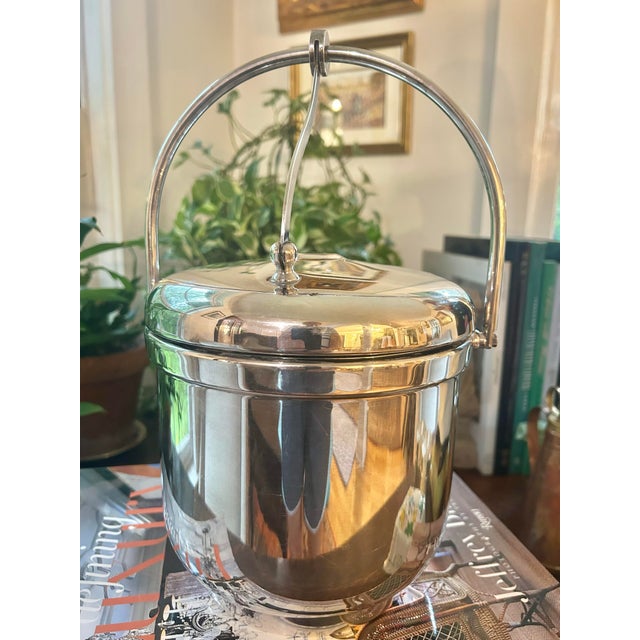 This is a vintage silver-plated ice bucket by The Sheffield Silver Co., Made in U.S.A., dating to approximately the...