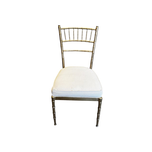 Set of 6 elegant dining chairs featuring a classic bamboo-style frame in a warm metallic finish. The slender silhouette...