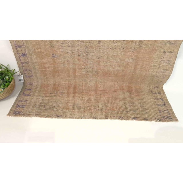 This vintage hand-knotted area rug is a semi-antique vintage area rug. The '70s Eastern Anatolian region's unique rug is...