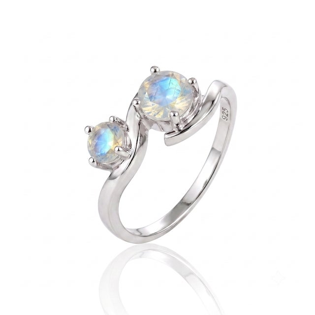 Crafted with fluid curves that wrap around twin gemstones, this ethereal ring brings a sense of soft movement and...