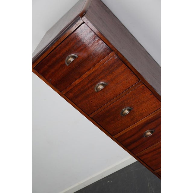 This apothecary cabinet was made circa 1950s in the Netherlands. It features 6 drawers with brass handles. The interior...