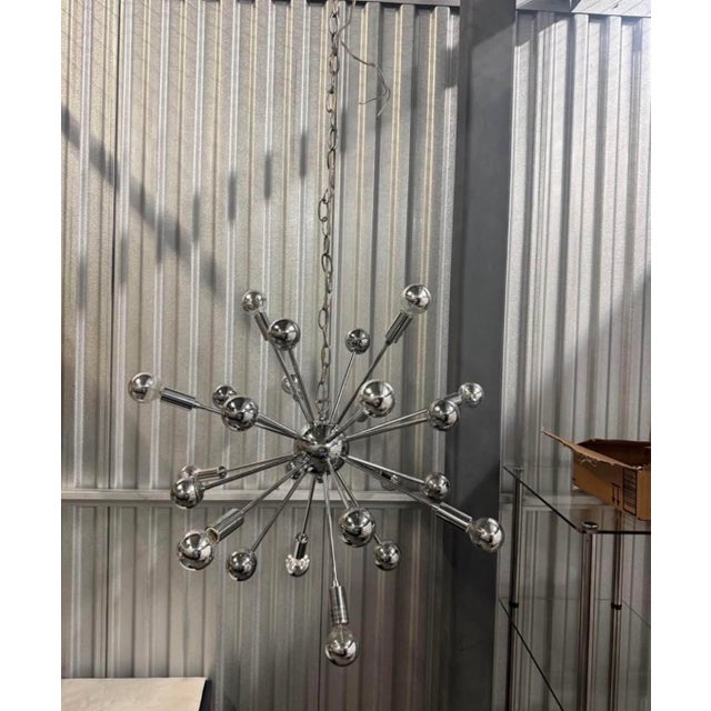 12 Light Sputnik Style Chandelier 24” In Diameter Chrome Finish This is a chrome sputnik-style chandelier, which appears...