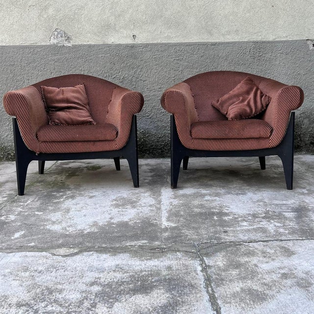 Original pair of padded armchairs, mounted on painted wooden cross structures. The shell of the seats is shaped to...