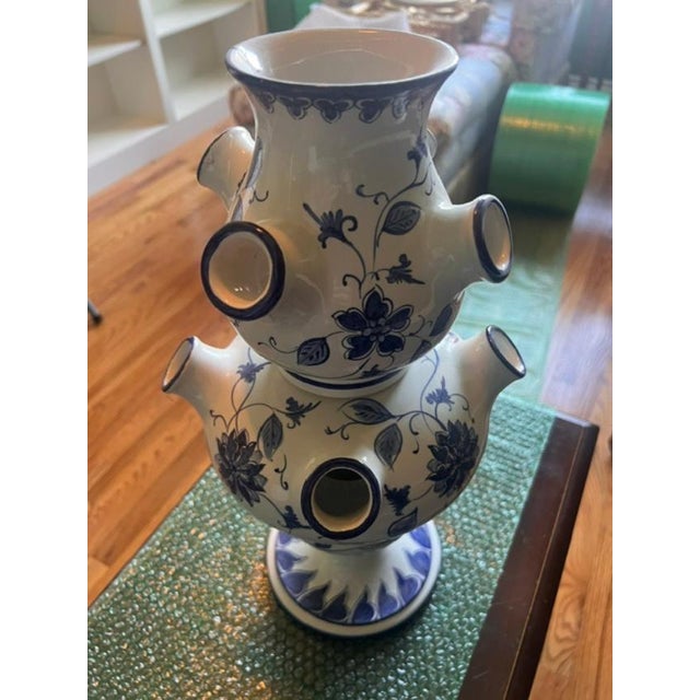 This is a multi-spouted ceramic vase designed specifically for displaying tulips individually, a traditional style rooted...