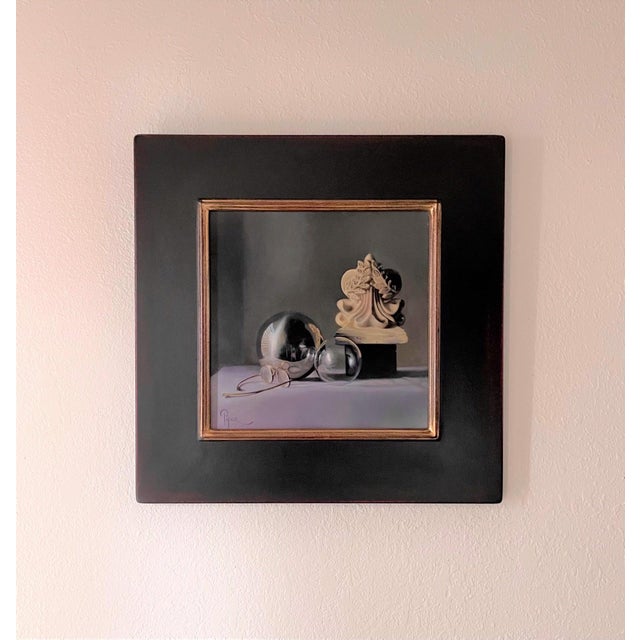 This oil on panel artwork features a harmonious arrangement of reflective spheres and a sculptural form, all set against a...