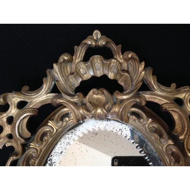 Tiffany & Co bronze cast mirror circa 1910-1920's. Original beveled mirror, with original leather back. 12" wide at the...