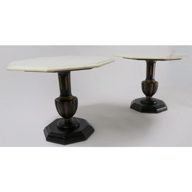 Stylish pair of side or end tables each having an octagonal marble top, supported by a polychrome (gold and black) wood...