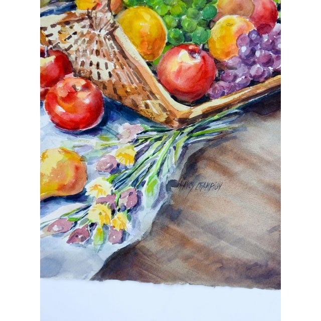 Circa 1990's watercolor on paper still life with fruit and flowers. Includes pears, grapes and apples. Signed Nancy...