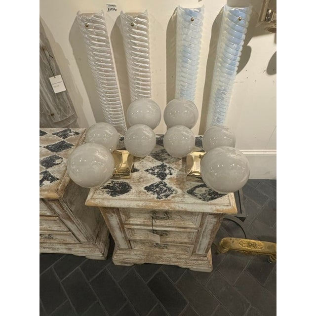 The Pair of Murano Glass Grey Ball Cloud Sconces is a unique piece inspired by the renowned glassmaking techniques of...