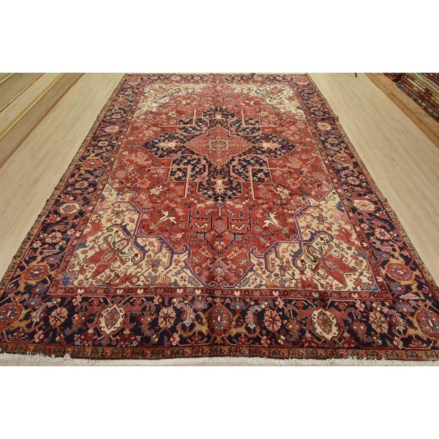 This authentic vintage traditional Heriz rug is hand-knotted with fine wool and natural dyes. This beautiful oriental rug...