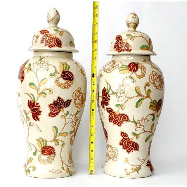 Offering a Monumental pair of 20 inch beige crackled Chinese porcelain temple jars with burgundy flowers done with...