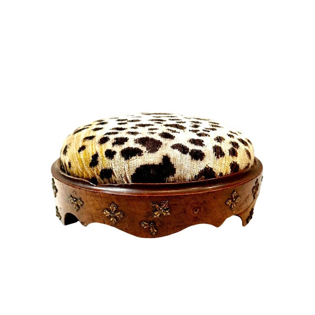 A lovely 1880s round carved wooden footstool with brass. Upholstered in 1970s silk Scalamandré animal print fabric.