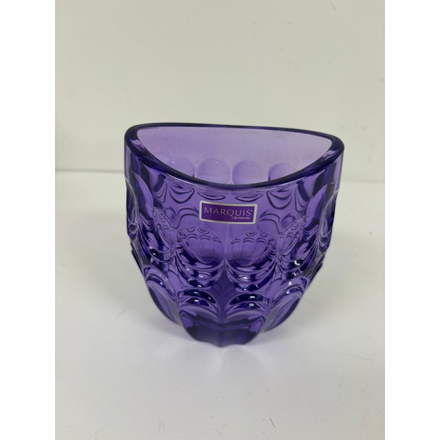 Purple crystal glass vase by Marquis by Waterford featuring a raised geometric pattern with circular and curved designs....