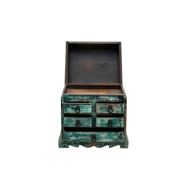 This is a small, vintage wooden cabinet with a distinctly distressed appearance, exuding rustic charm. The cabinet is...