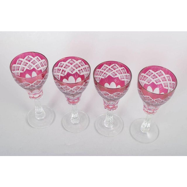 Set of four Bohemian wine glasses. Pink crystal glasses with cut and etched decoration in the classic Bohemian style. The...