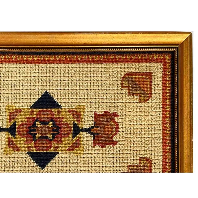 Mid century geometric needlepoint in gold frame.