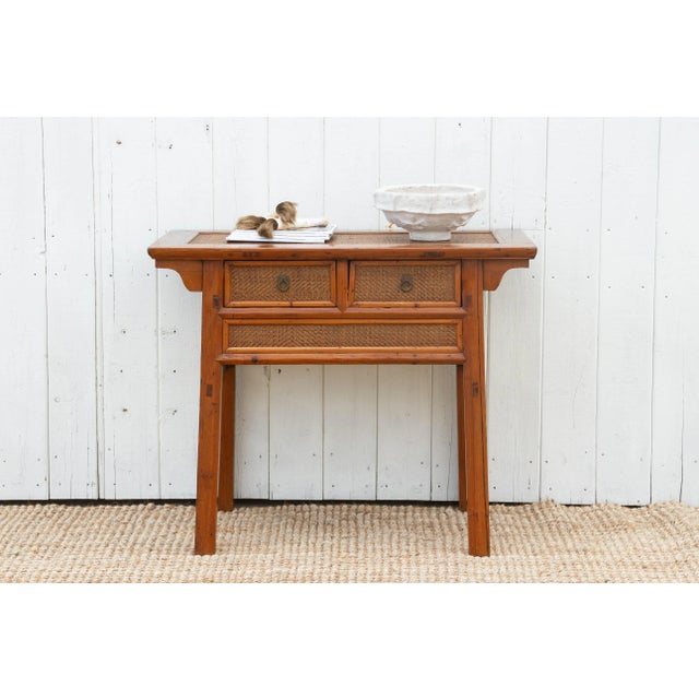 A unique blend of farmhouse charm and Asian heritage, this vintage console table offers a charming conversation starter...