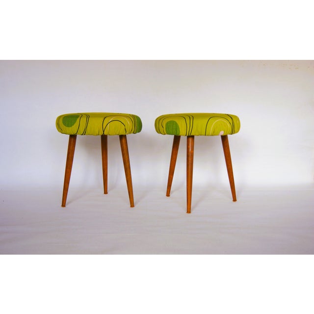 Pair of three leg teak wood stools with later upholstered seats with green design fabric. Denmark approx. 1960s....