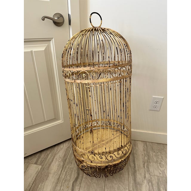 Beautiful oversized birdcage, featuring an ornate domed top and bottom. Intricate scrollwork detailing with a distressed...