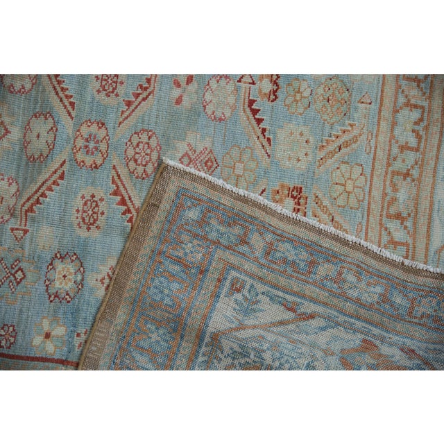 :: Covered field in bursting floral central design elements and serrated leaves stemming therefrom atop a heavily abrashed...