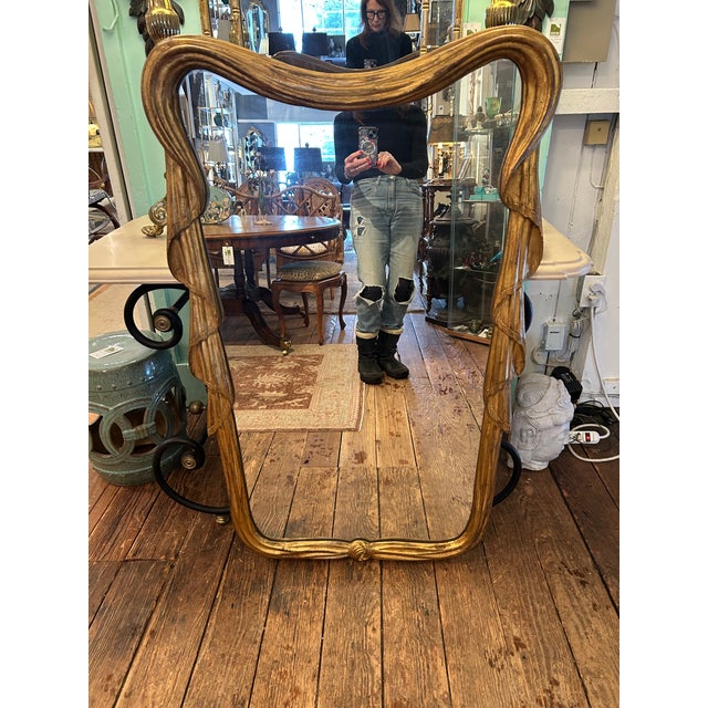 A rare pair of glamorous large carved giltwood art nouveau French vertical mirrors having the effect of swagged drapery....