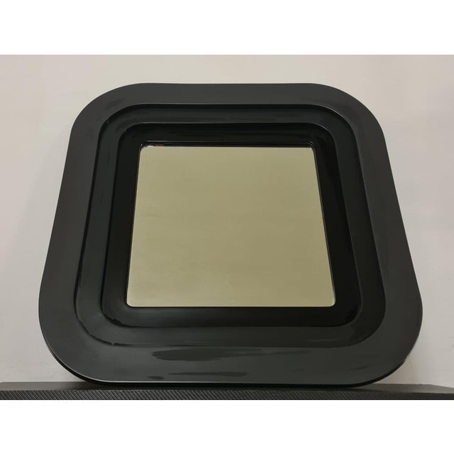 70s mirror Modern mirror with embossed frame in gray and black lacquered wood. with a Pop style typical of the 70s, with a...