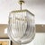 Exceptional extra large vintage Hollywood tegency gold lucite ribbon loop chandelier. In the style of Carlo Nason this...