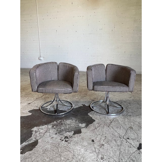 Vintage club chairs featuring new black and white houndstooth plaid fabric, silver accents and chrome swivel base....