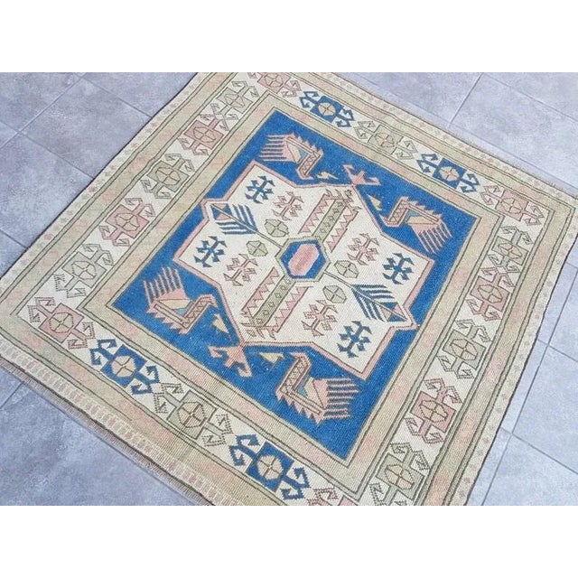 This is a vintage Turkish Oushak rug from the 1960s. The piece was hand-knotted.