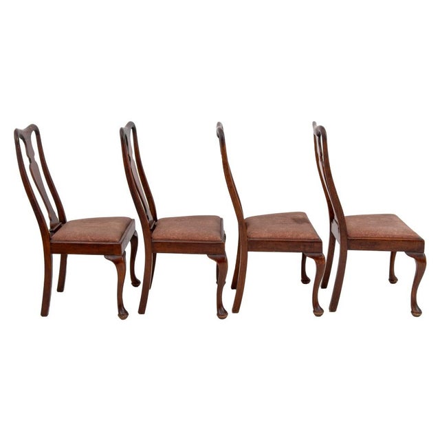 Set of four Queen Anne style Walnut dining or side chairs with upholstered seats in a dusty rose fabric and cabriole legs....