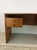 This Danish Modern writing desk features pressed wood construction, teak veneer with original finish, two dovetailed...
