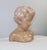Charming sculpture in patinated terra cotta, pink-orange color, representing the bust of a child with a baby face. This...