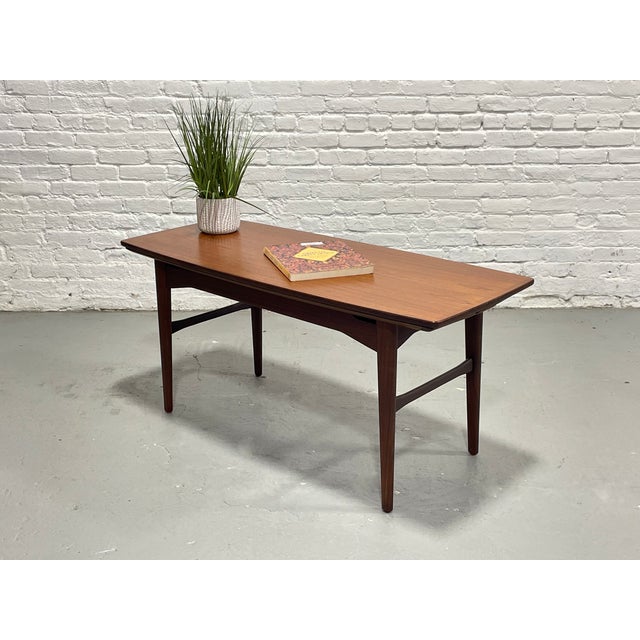 An exceptional example of Mid Century Modern ingenuity, this vintage convertible table offers seamless transformation from...